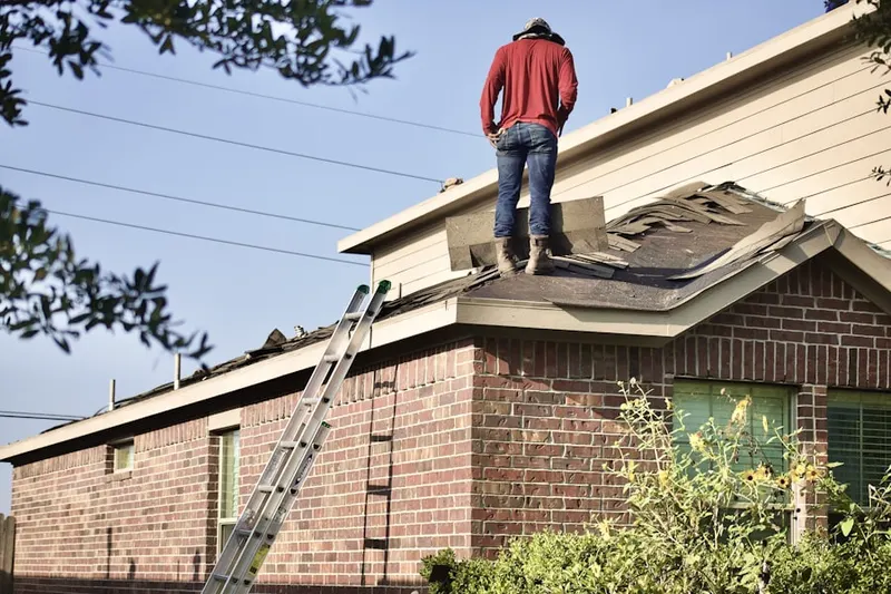 Professional roofer working on a residential roof in Charter
